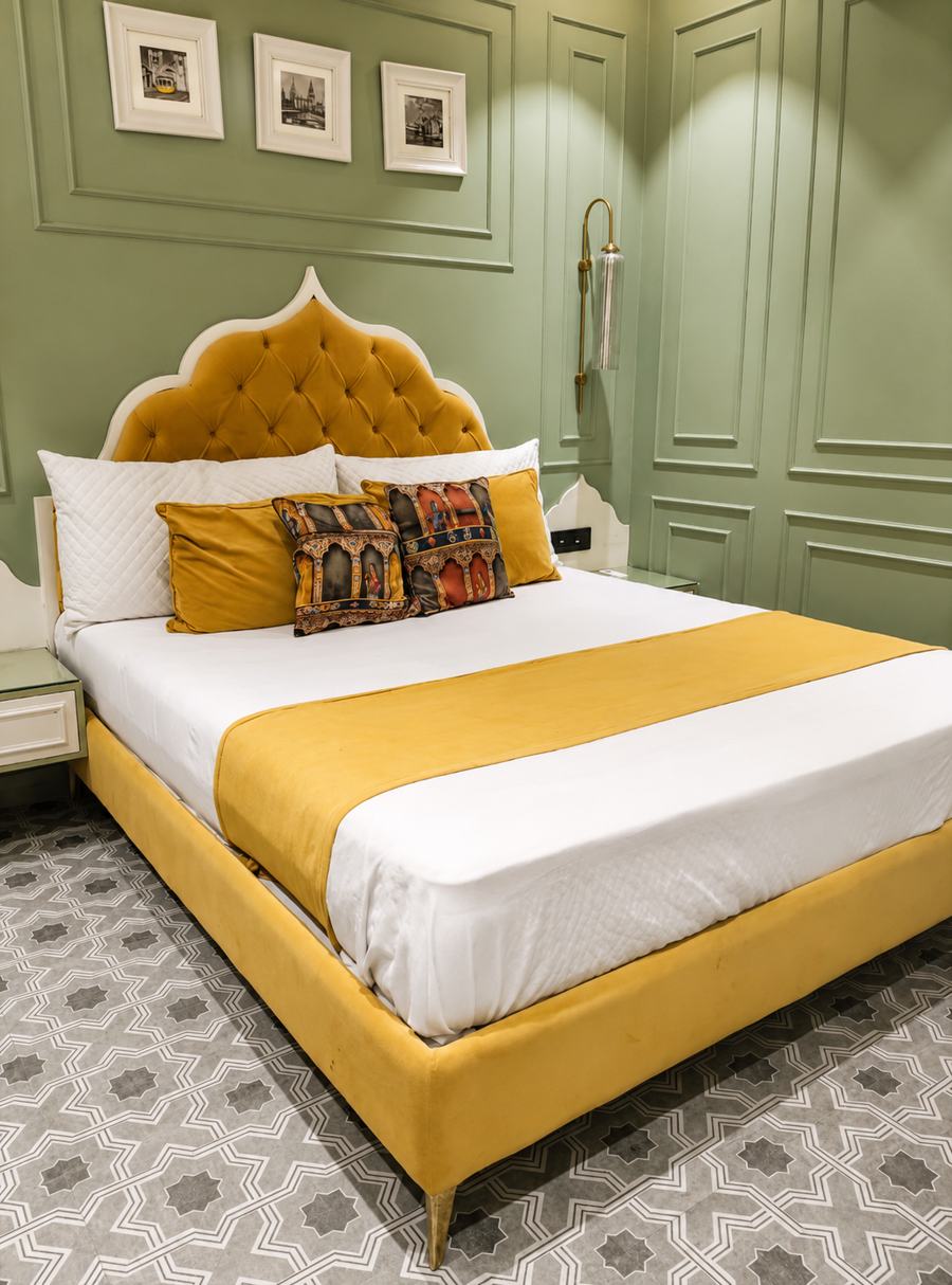 Mustard scalloped headboard against sage panelling